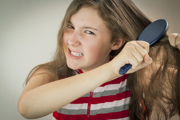  Teen girl combing hair