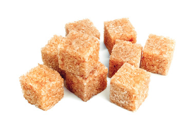 Lump brown cane sugar cubes isolated on white background
