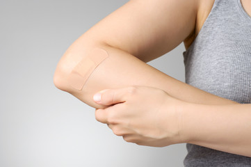 Plaster on female arm