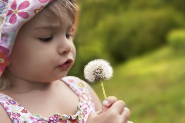 Kid Blowing On A Dandelion