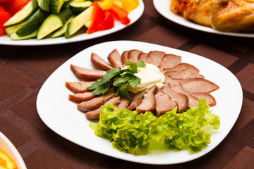Dish with sliced meat products