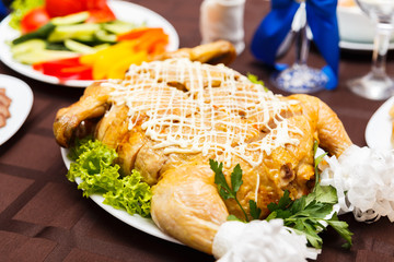 Roasted chicken on white plate.