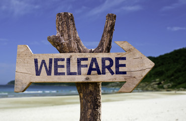 Welfare wooden sign with a beach on background