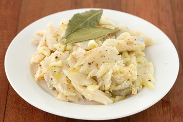 codfish on plate on brown background