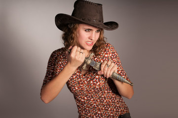 studio shot of young warrior woman holding sword in her hand