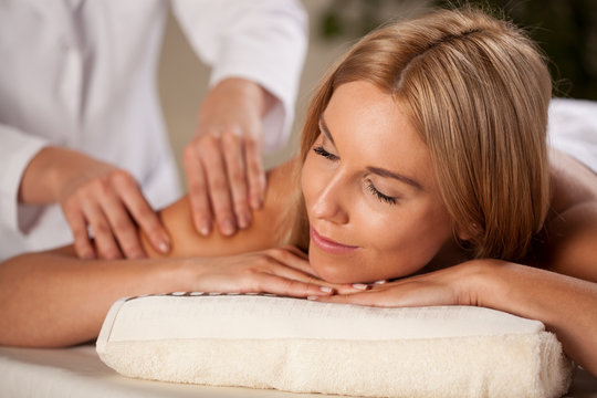 Beautiful woman having arm massage