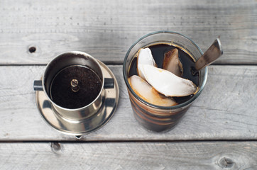 Vietnamese iced coffee against wooden background