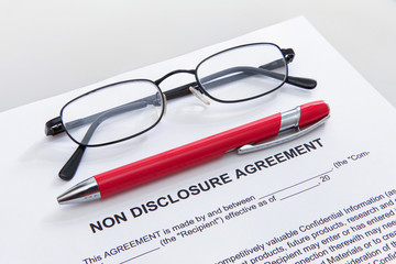 Non disclosure agreement with pen and glasses