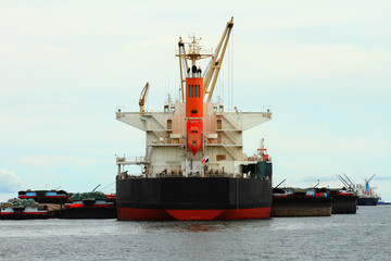 Fototapeta premium Vessel cargo with crane are working in the sea.