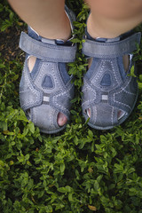 Child's legs on green grass