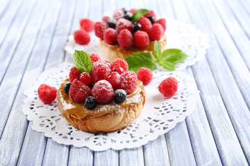 Sweet cakes with berries on table close-up