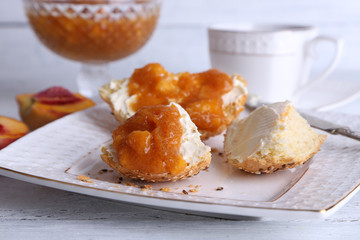 light breakfast with cup of tea and homemade jam on wooden