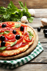 Delicious pizza served on wooden table