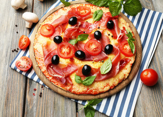 Delicious pizza served on wooden table