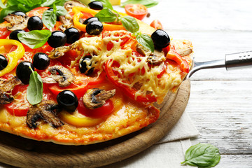 Delicious pizza served on wooden table