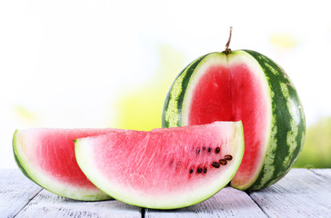 Watermelon on wooden table on natural background