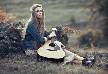 Beautiful hippie girl with guitar