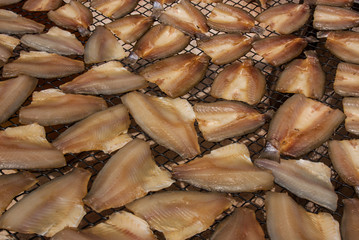 Dried fish slices on the grid.