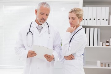 Concentrated doctors coworker analyzing results