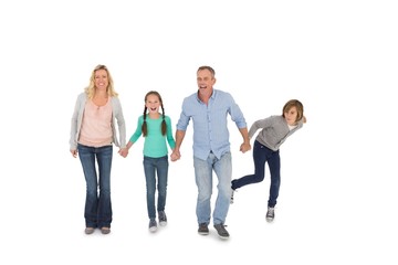Fototapeta premium Happy family of four walking hand in hand