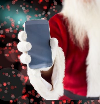 Composite image of santa claus showing smartphone