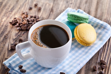 Cup of coffee and french macaron.