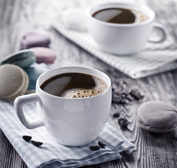 Cup of coffee and french macaron.