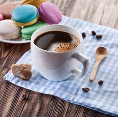 Cup of coffee and french macaron.