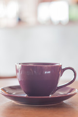 Violet mug on wooden table