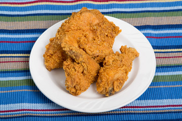 Fried Chicken on Small White Plate and Striped Placemat