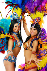 Two smiling beautiful girls in a colorful carnival costume