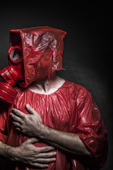Ebola infection concept, man with red gas mask
