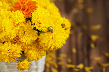 Beautiful bouquet of yellow chrysanthemums flowers in wicker ba