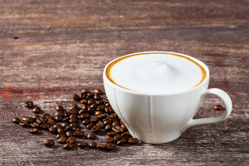 Cup of coffee on old wooden table