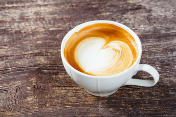 Cup of coffee on old wooden table