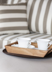 Fototapeta na wymiar Living room sofa and coffee in wooden tray