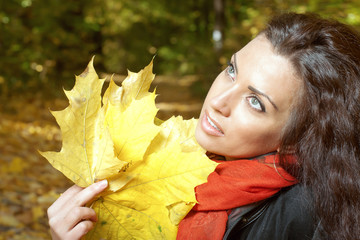 Girl holding yellow leaves