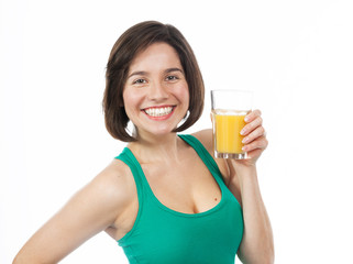 Cheerful young woman drinking an orange juice