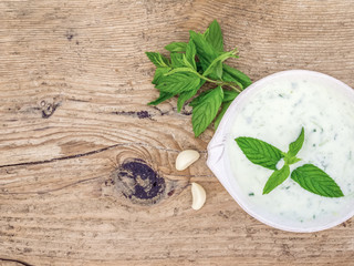 Cold summer yogurt and cucumber soup with fresh herbs
