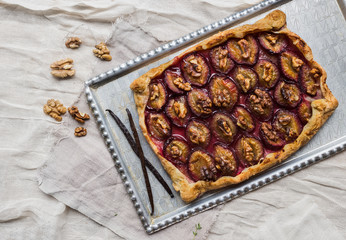 Rustic plum pie with walnuts and vanilla