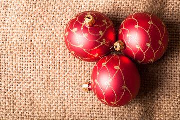 Three red Christmas tree ball on sacking