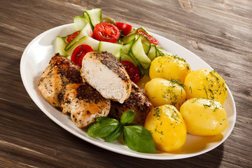 Fried chicken fillet, boiled potatoes and vegetable salad