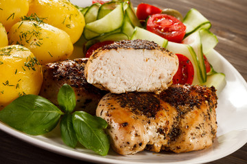 Fried chicken fillet, boiled potatoes and vegetable salad