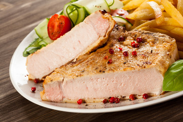 Fried pork chop, chips and vegetable salad