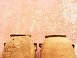 Clay amphoras near an old wall