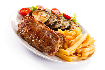 Grilled steak, French fries and vegetables