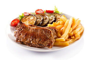 Grilled steak, French fries and vegetables