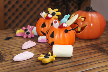 Smiling cookies with candies and pumpkins in Halloween festiviti