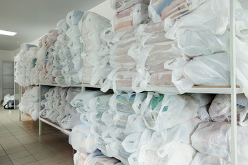 Racks with clean linen in laundry room
