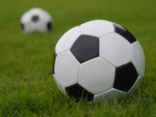 Fototapeta premium Soccer ball on green field